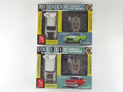 Lot 153 - A pair of AMT 1:32 scale slot car racing...