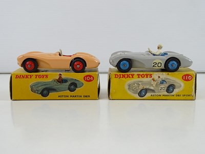Lot 85 - A pair of DINKY Aston Martins comprising a 104...