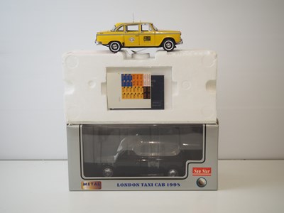 Lot 126 - A pair of diecast taxis - comprising of a...