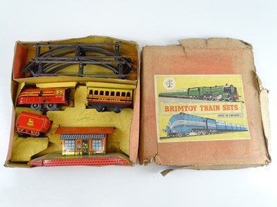 Lot 105 - A BRIMTOY O gauge clockwork tinplate train set...