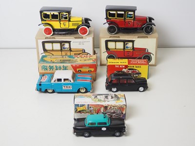 Lot 70 - A group of plastic and tin plate models of...