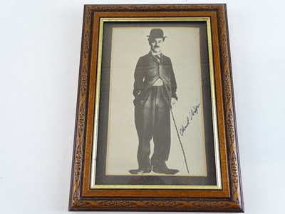 Lot 122 - A framed, signed black/white photograph of...