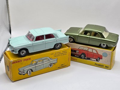 Lot 646 - FRENCH DINKY - A pair of Peugeot diecast cars...