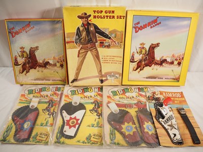 Lot 194 - Boxed and packaged gun and holster sets by...