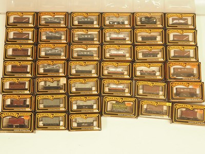 Lot 205 - A large group of OO gauge MAINLINE wagons,...