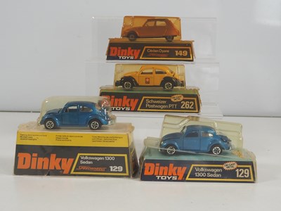 Lot 485 - DINKY - A group of four diecast cars in bubble...