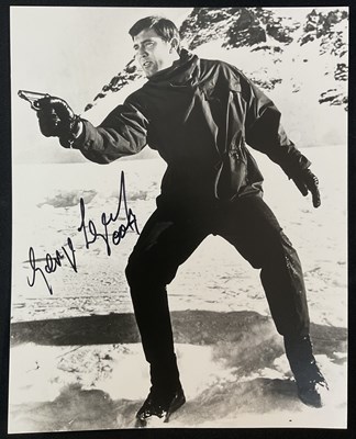 Lot 514 - JAMES BOND AUTOGRAPHS - An 8" x 10" black and...